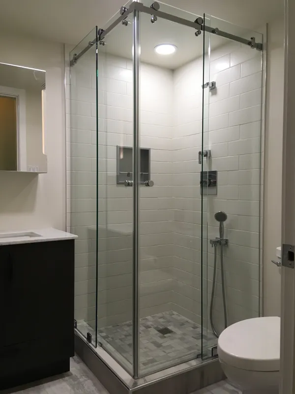 Frameless shower enclosure